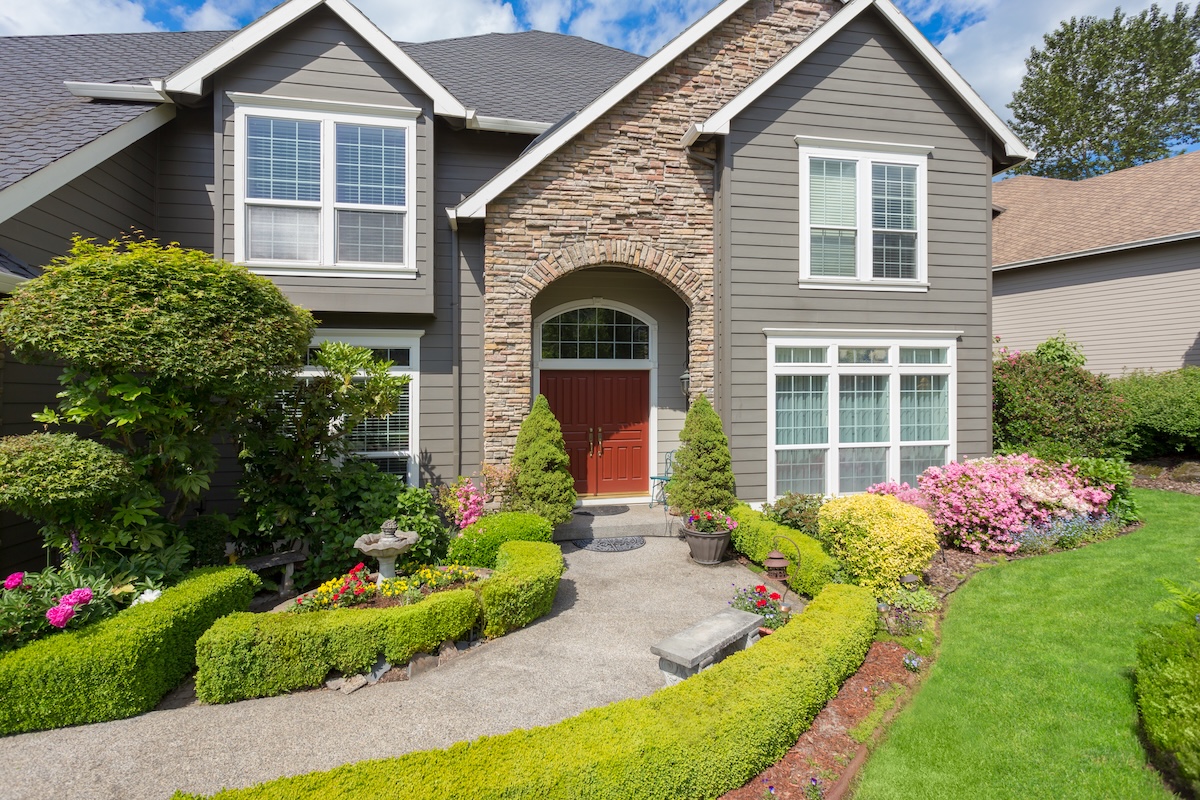 Beautiful home exterior with colorful plants on bright and sunny spring day