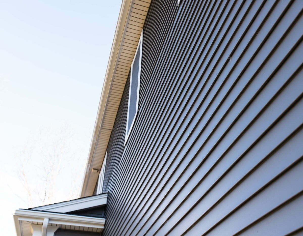 Dark vinyl siding and window treatments on new home how long does vinyl siding last