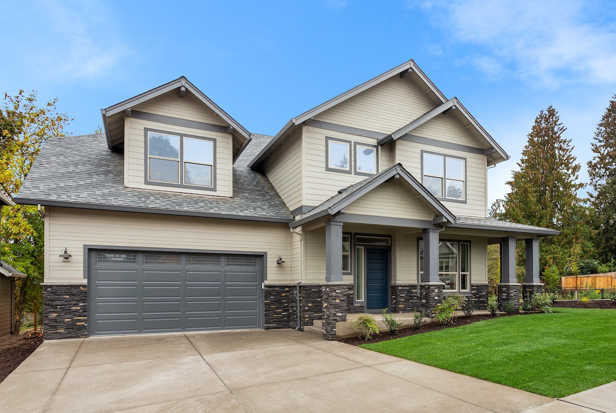 Exterior of new home on bright sunny day with blue sky