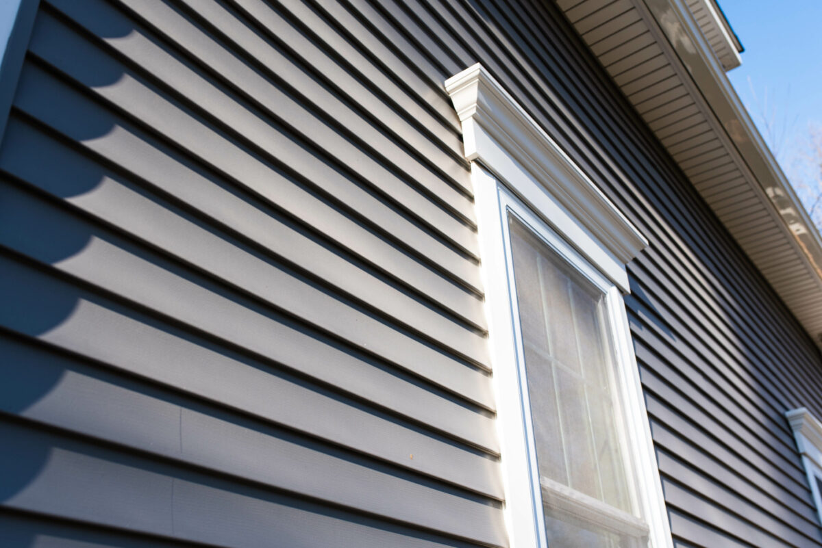 Dark vinyl siding in residential neighborhood, new window treatm