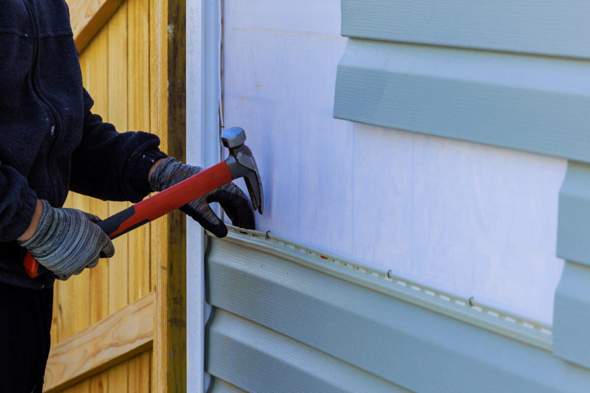 Replacing plastic siding on an exterior wall of residence house siding repair cost