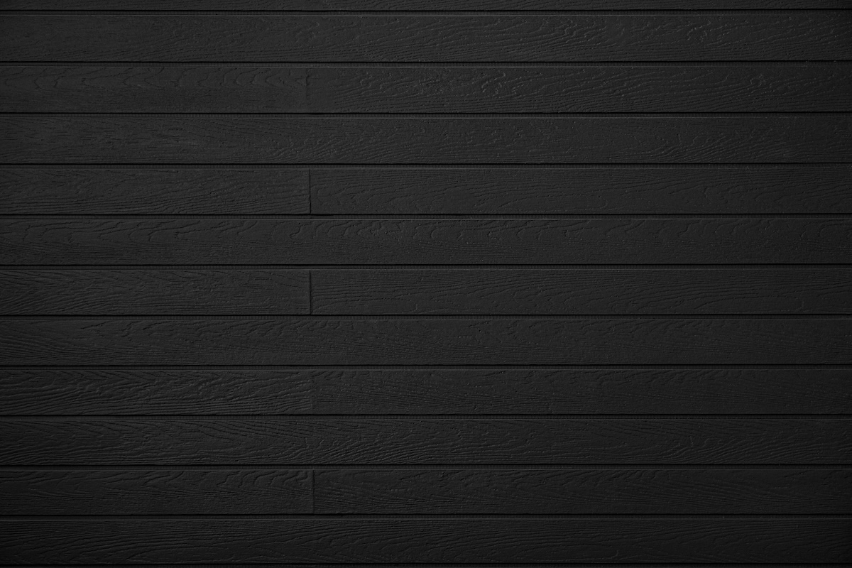 Wood texture - Black Imitation wood board textured vinyl. Wood Plastic Composite Panel Wpc interior and exterior wall siding decorative paneling. Table background,