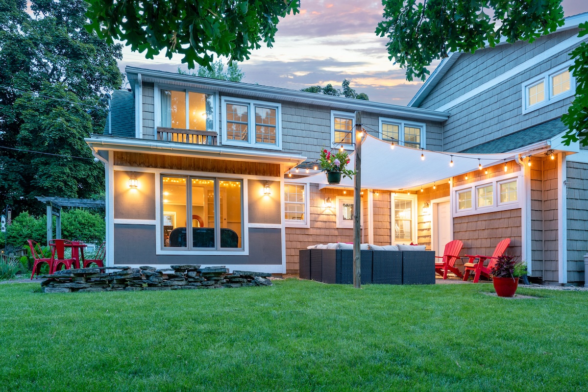 Home with shake siding and a backyard patio