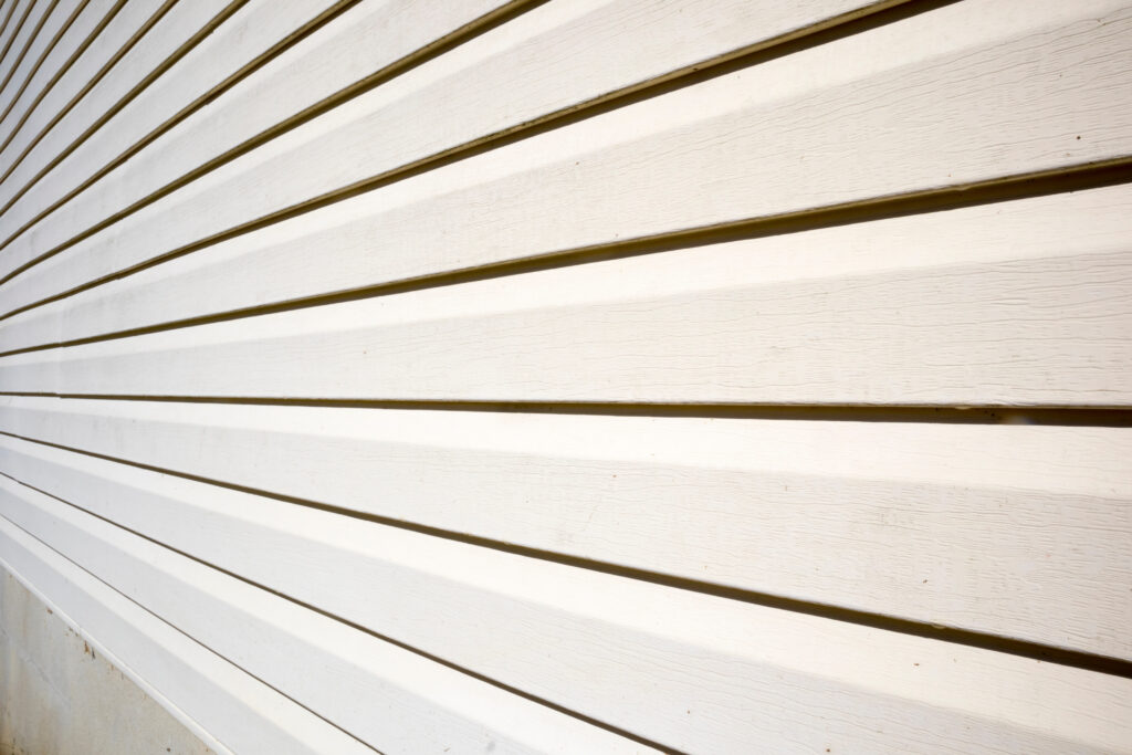 House with pale yellow vinyl siding lap siding