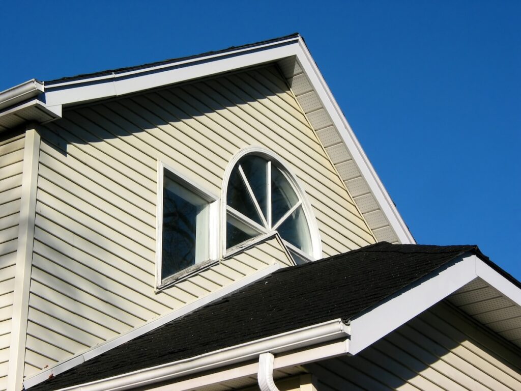 lap siding Fragment of a house on with bright blue sky