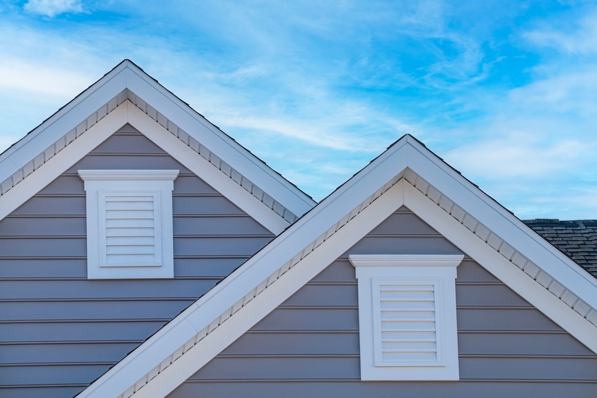Gray lap siding with white gable trim